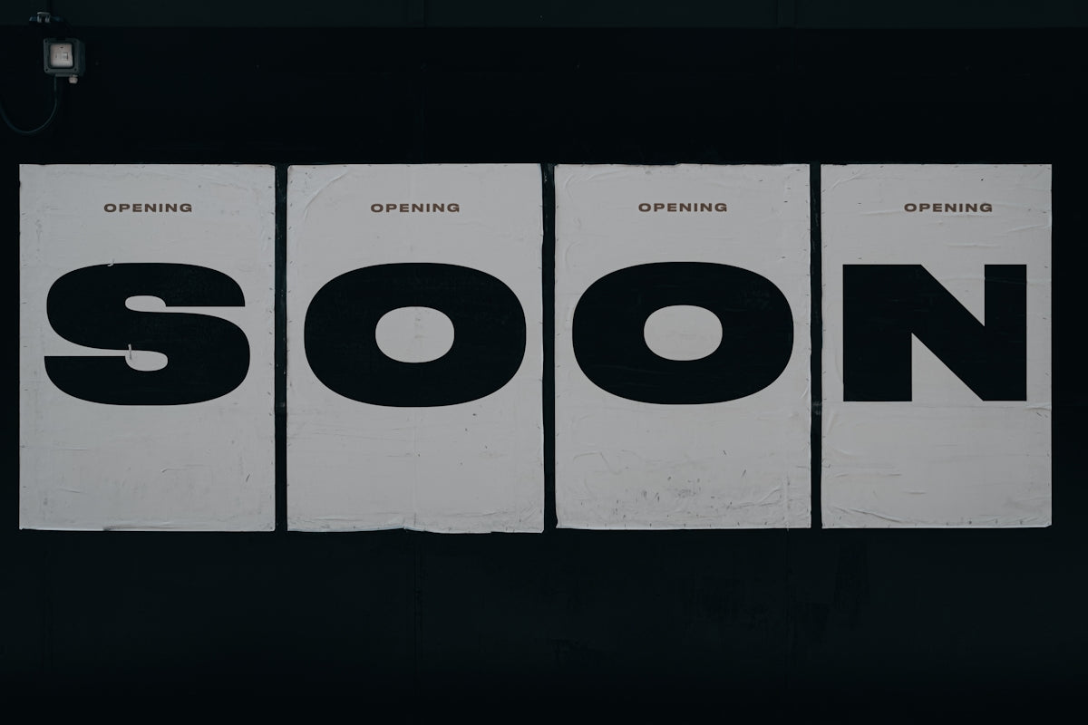 a black and white photo of a sign that says soon