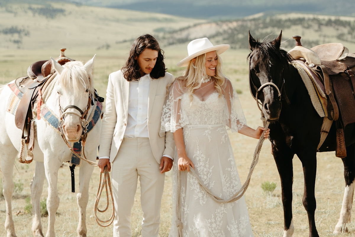 A man and a woman standing next to a horse
