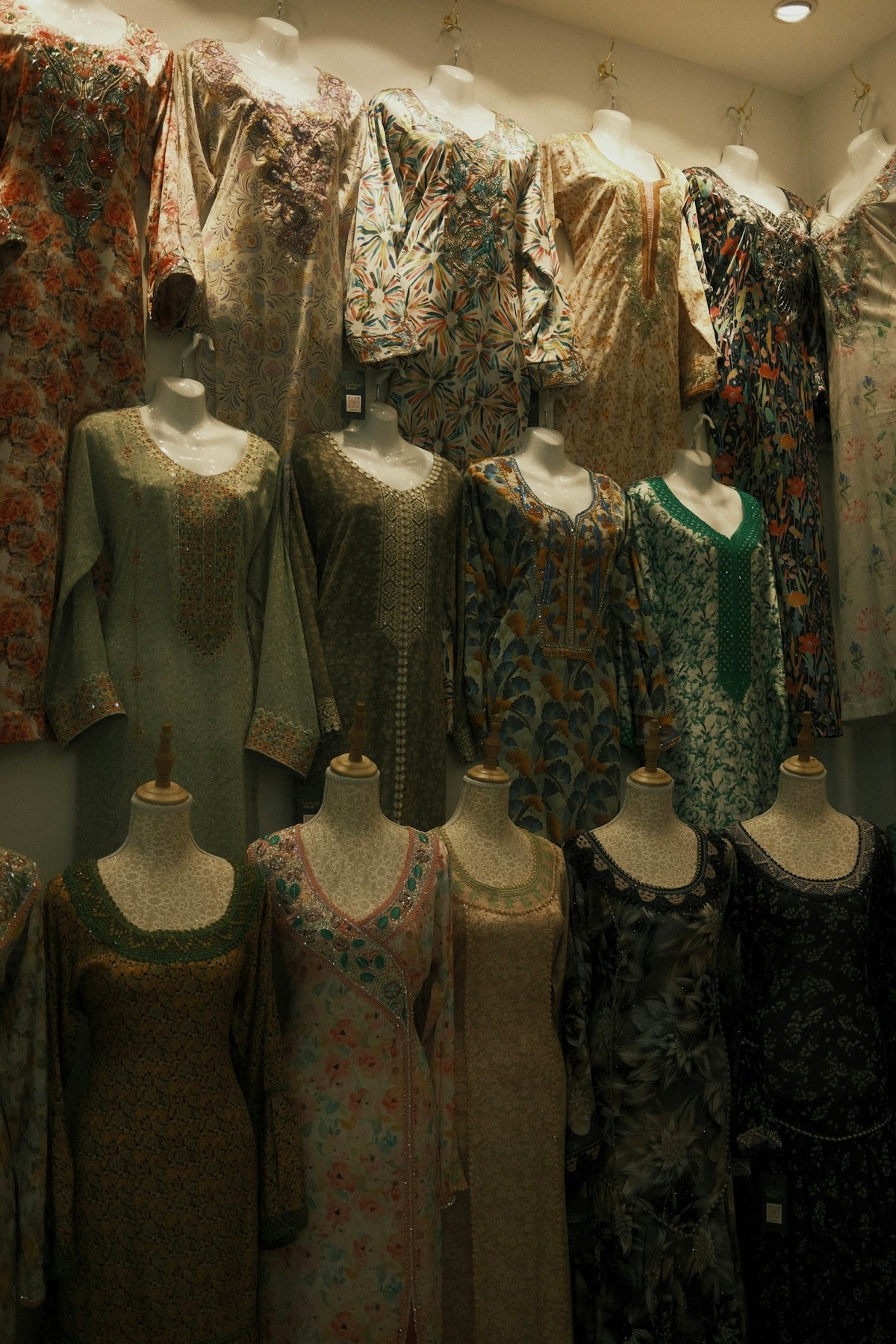 A room filled with lots of mannequins and dresses